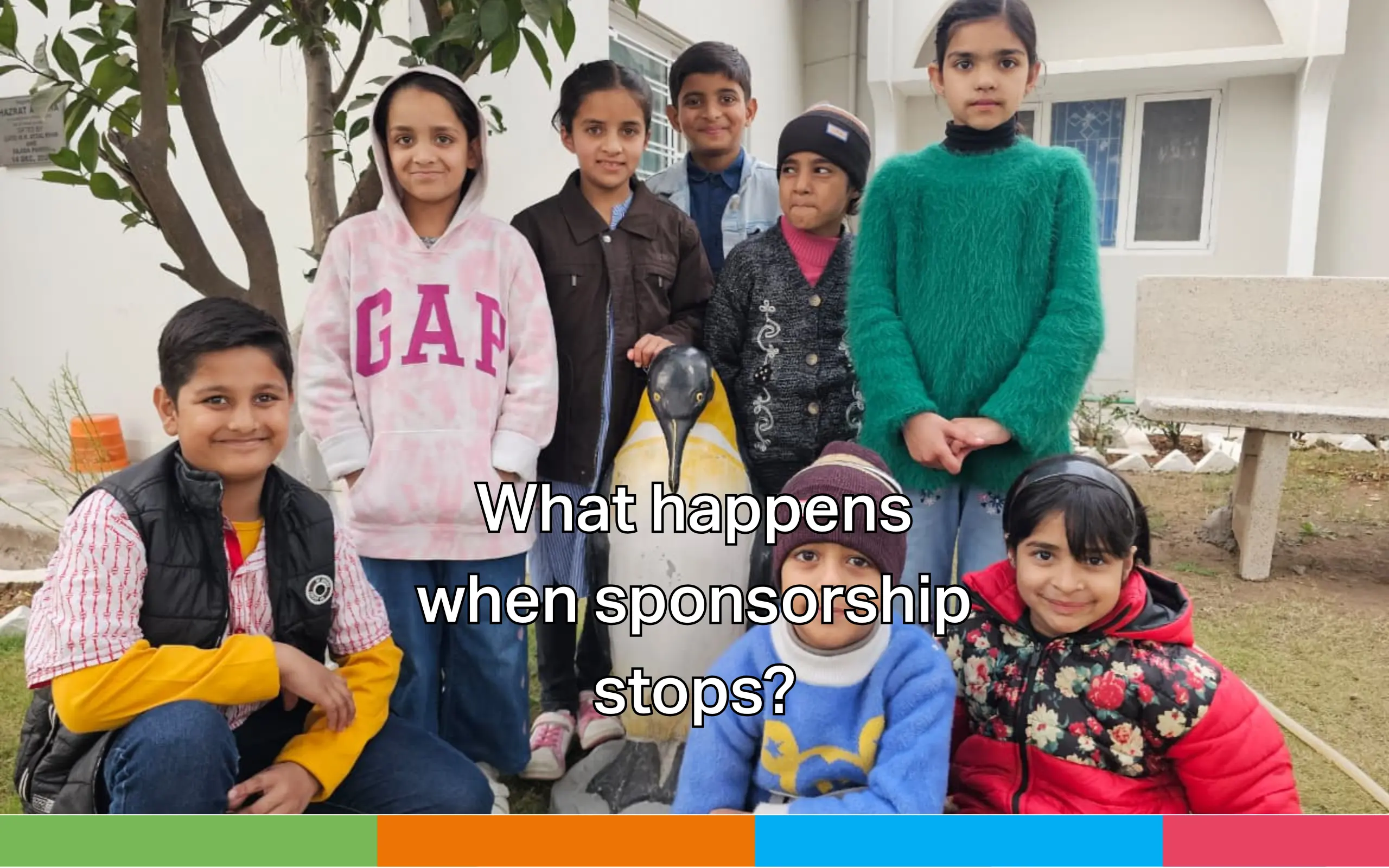 A group of children gathered outside a building, smiling at the camera, with an overlay message asking, ‘What happens when sponsorship stops?